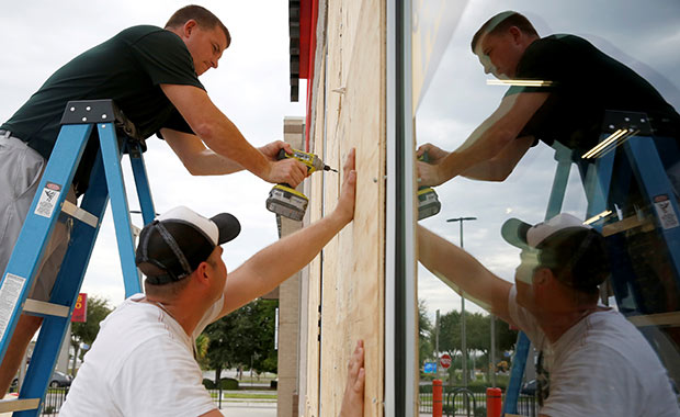 Two men board up a business in advance of Hurricane Michael in Destin, Florida.