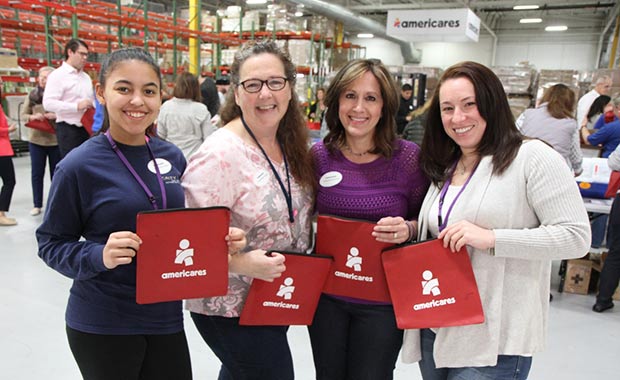 Boehringer Ingelheim volunteers Jennifer Grant, Jeannine Gagnon, Christine Zarrella and Meaghan Hart assemble first aid kits in Americares distribution center in Stamford, Conn. 